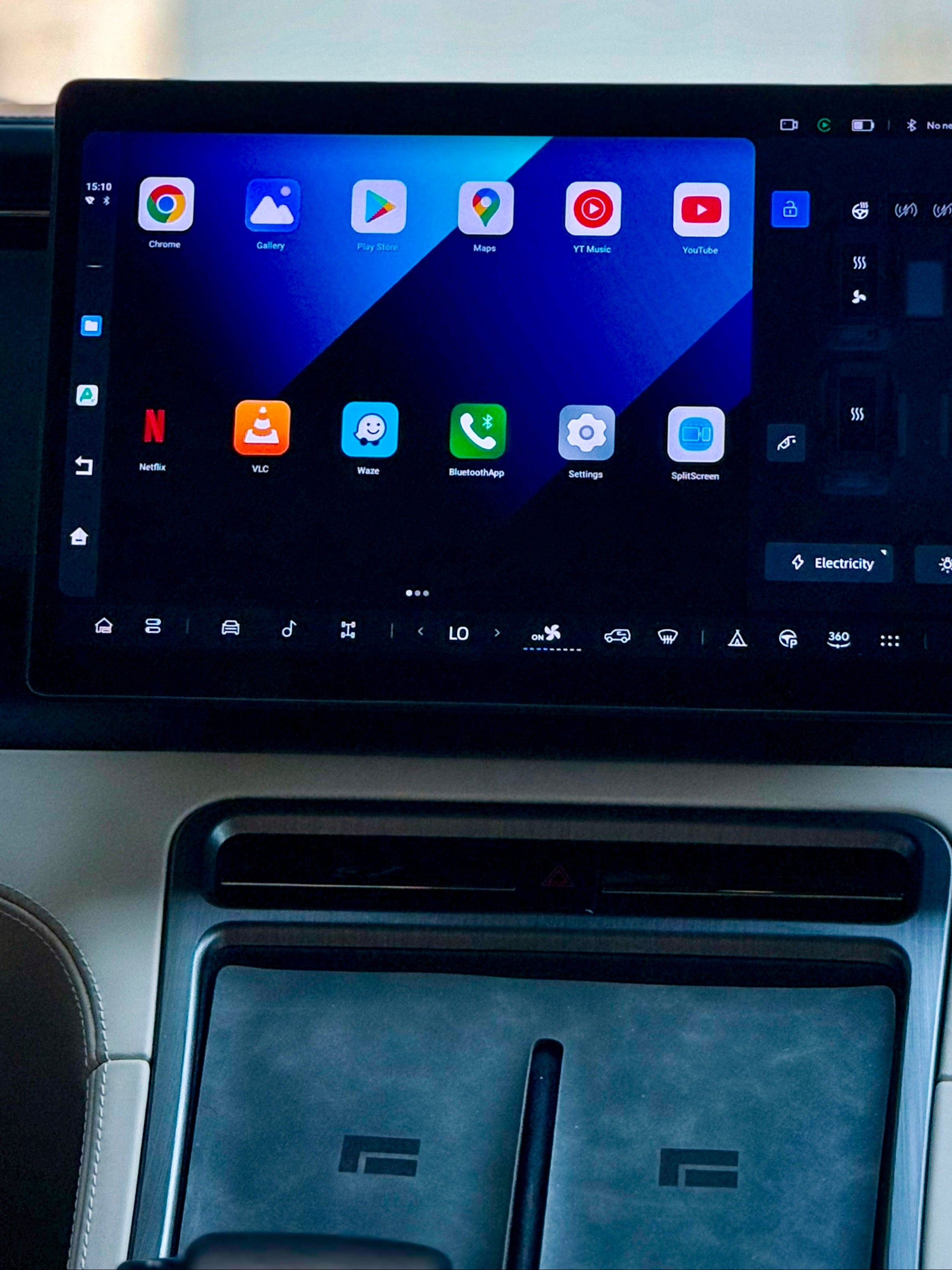 Car dashboard with a touchscreen display showing app icons